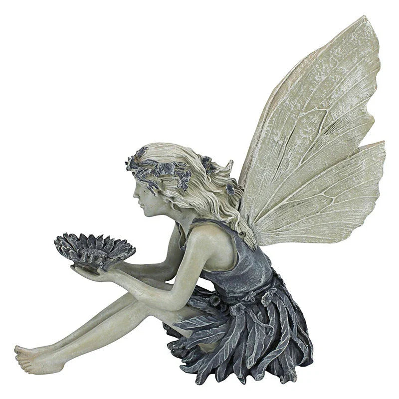 A charming resin fairy statue holding a sunflower bowl, with a flower crown and petal-inspired skirt, designed for outdoor garden decor