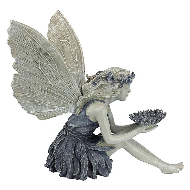 A charming resin fairy statue holding a sunflower bowl, with a flower crown and petal-inspired skirt, designed for outdoor garden decor