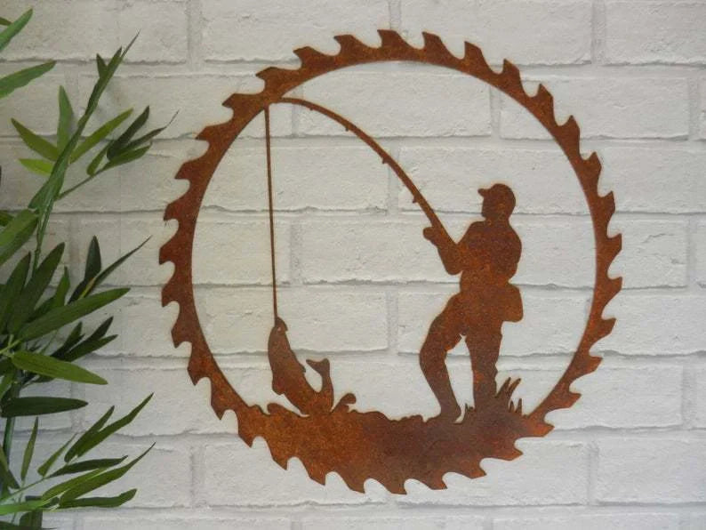 Handcrafted metal pendant with a father and child fishing scene, set in a circular saw blade frame