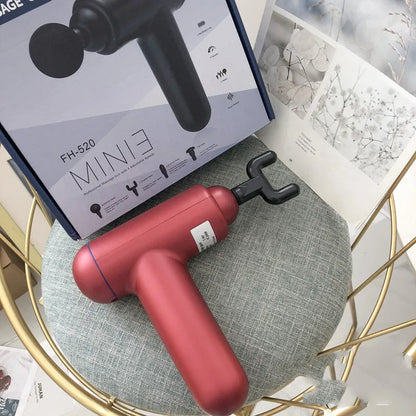 Grey handheld percussion muscle massager with USB charging port and rubberised grip