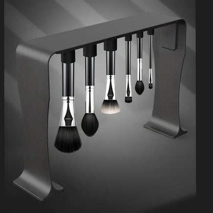 Black magnetic make-up brush drying rack with 12 silicone caps on desktop