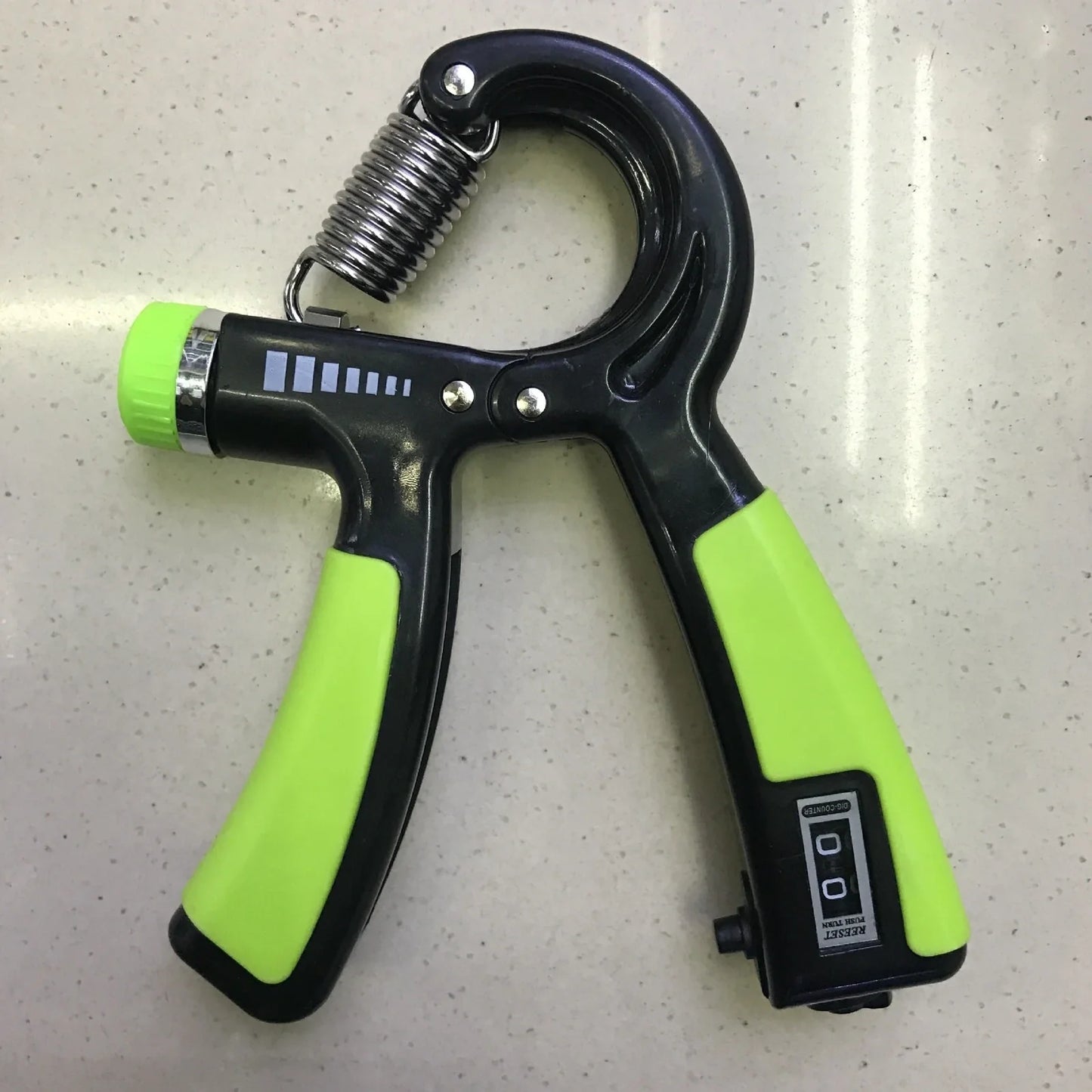 Adjustable hand gripper with digital display showing repetition count and resistance dial