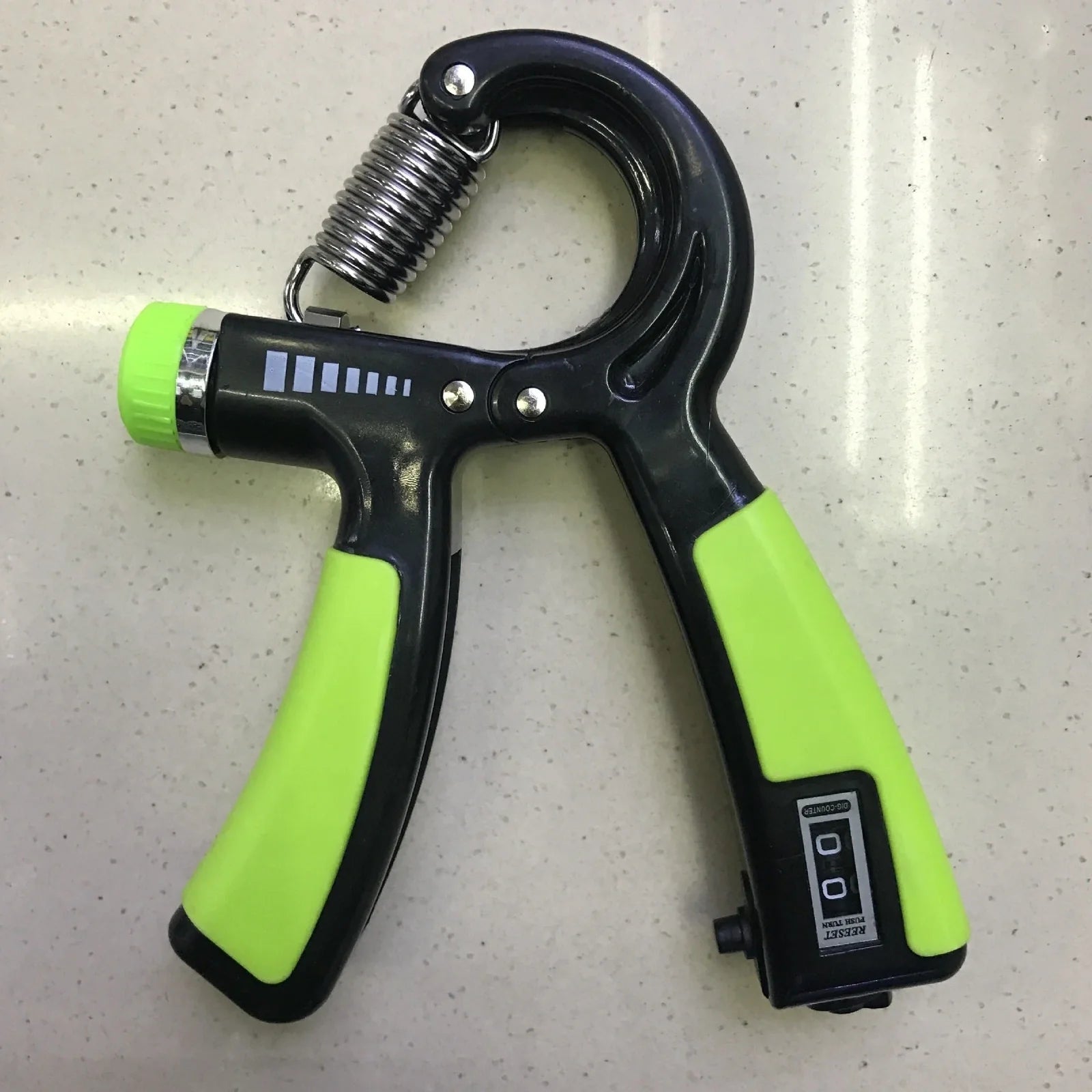 Adjustable hand gripper with digital display showing repetition count and resistance dial