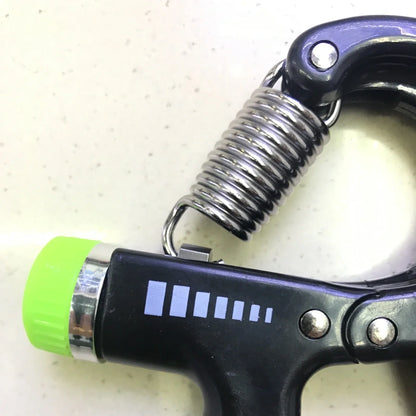 Adjustable hand gripper with digital display showing repetition count and resistance dial