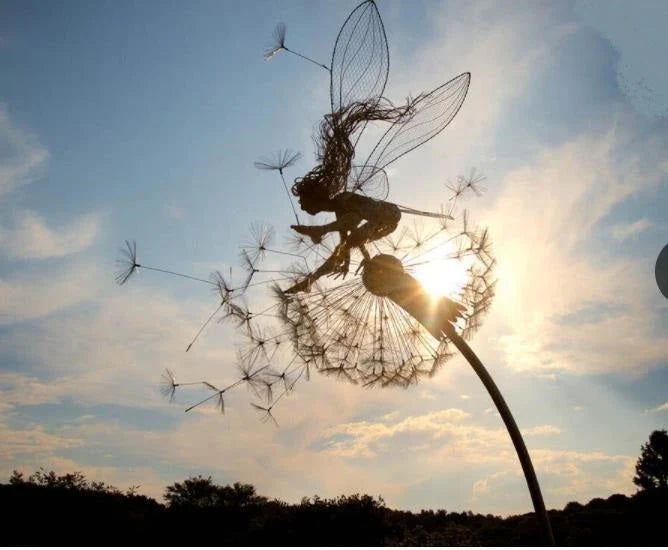Enchanting metal fairy garden sculptures in the shape of fairies and pixies dancing on dandelions, designed for year-round outdoor or indoor display
