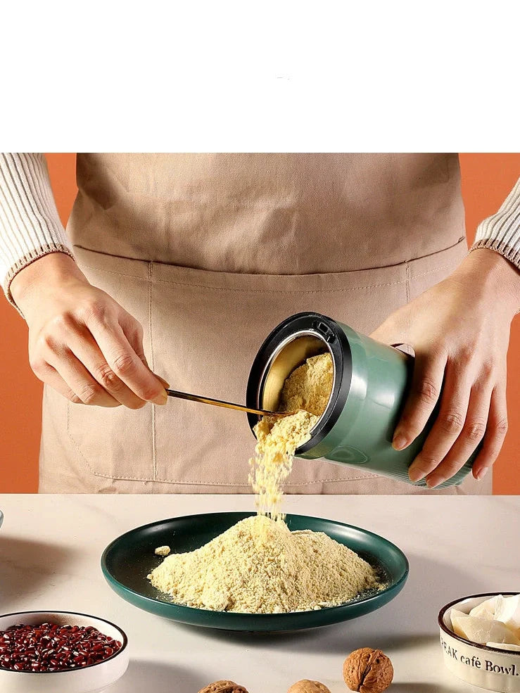 Small household grinder in green or white colour with 120g capacity for milling grains and coffee beans