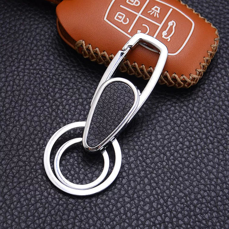 Heart-shaped leather and metal keychain in various colors