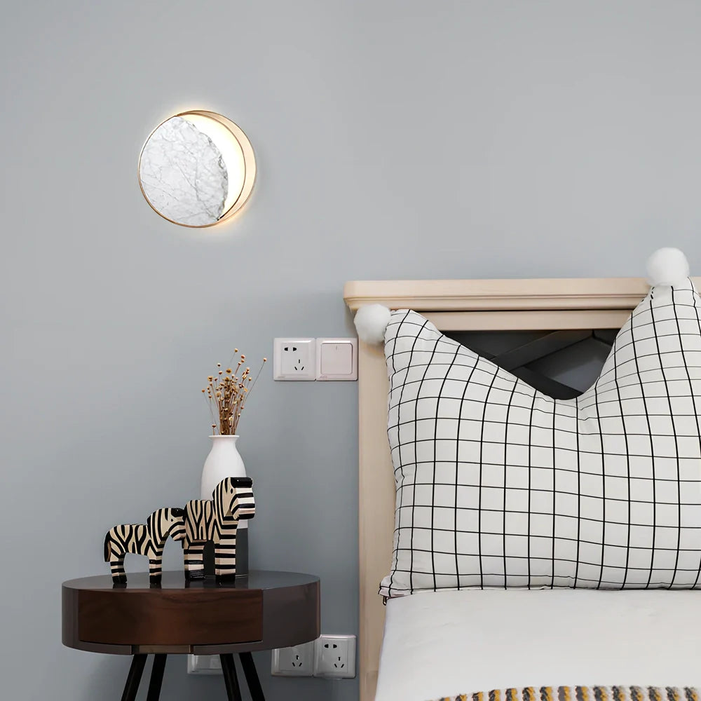 Circular marble wall lamp with copper accents, 25cm diameter, mounted beside bed