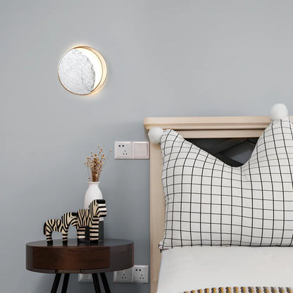 Circular marble wall lamp with copper accents, 25cm diameter, mounted beside bed