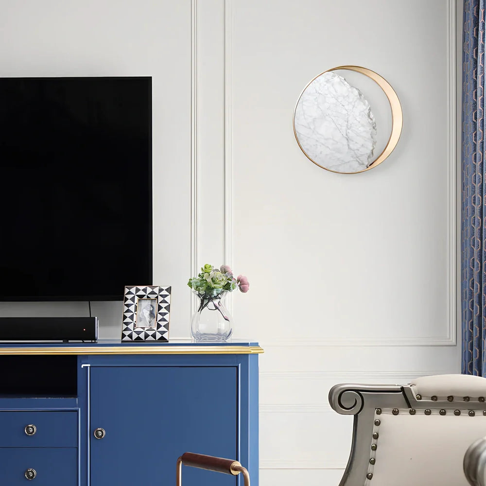 Circular marble wall lamp with copper accents, 25cm diameter, mounted beside bed