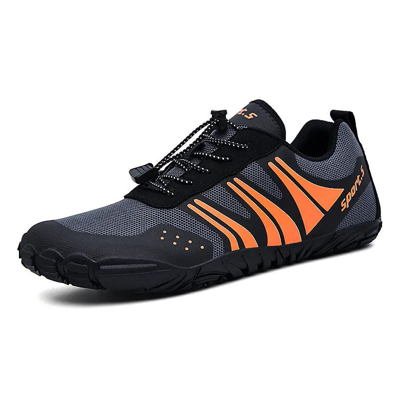 Casual red outdoor wading shoes with mesh upper and textured rubber sole on a sandy beach.