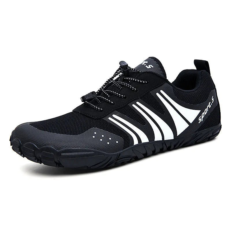 Casual red outdoor wading shoes with mesh upper and textured rubber sole on a sandy beach.