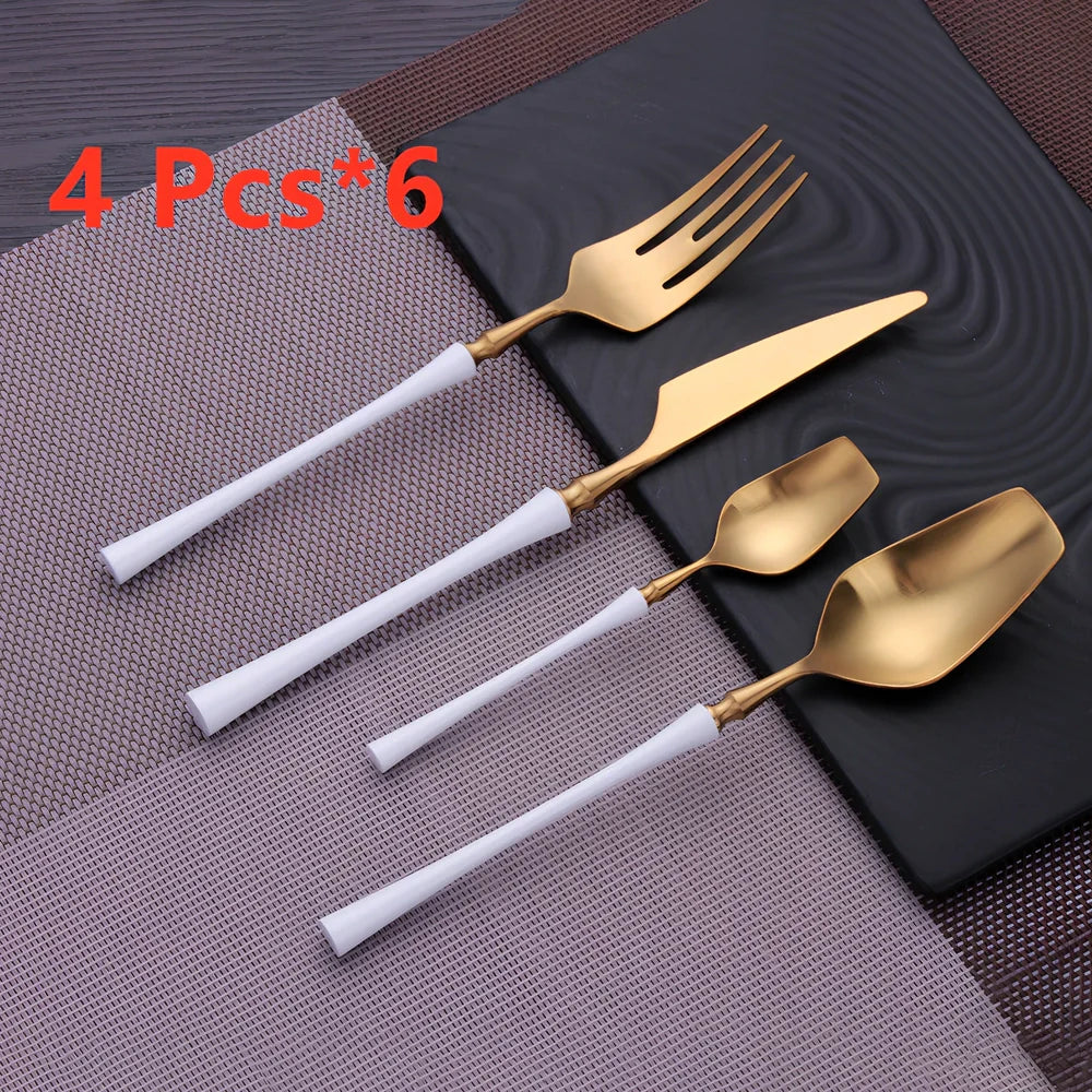 Four-piece stainless steel cutlery set showing main knife, fork, spoon, and teaspoon with mirror finish