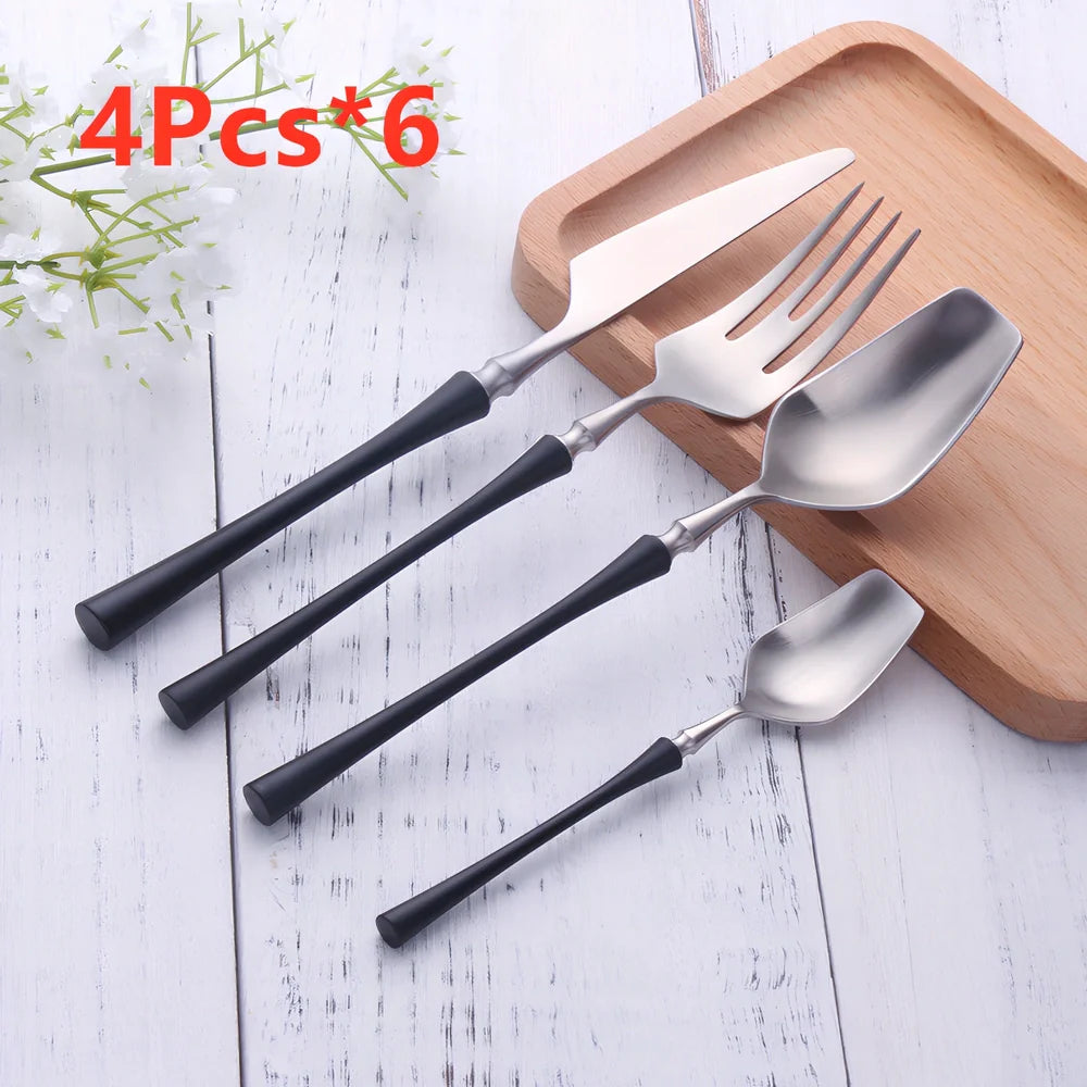Four-piece stainless steel cutlery set showing main knife, fork, spoon, and teaspoon with mirror finish