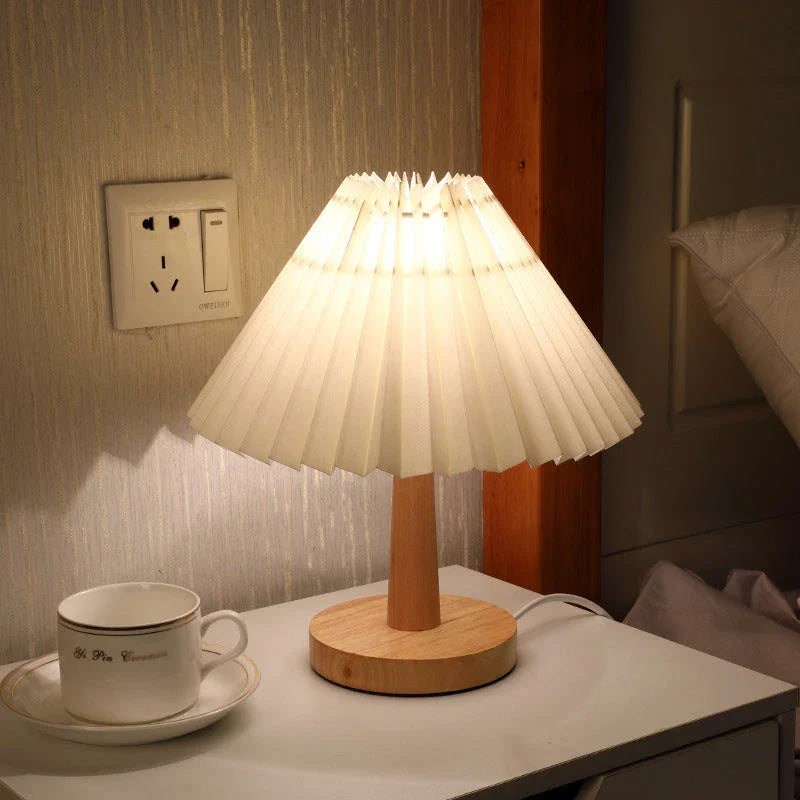 Vintage-inspired desk lamp with a pleated fabric shade, bamboo base, and touch-sensitive dimming controls