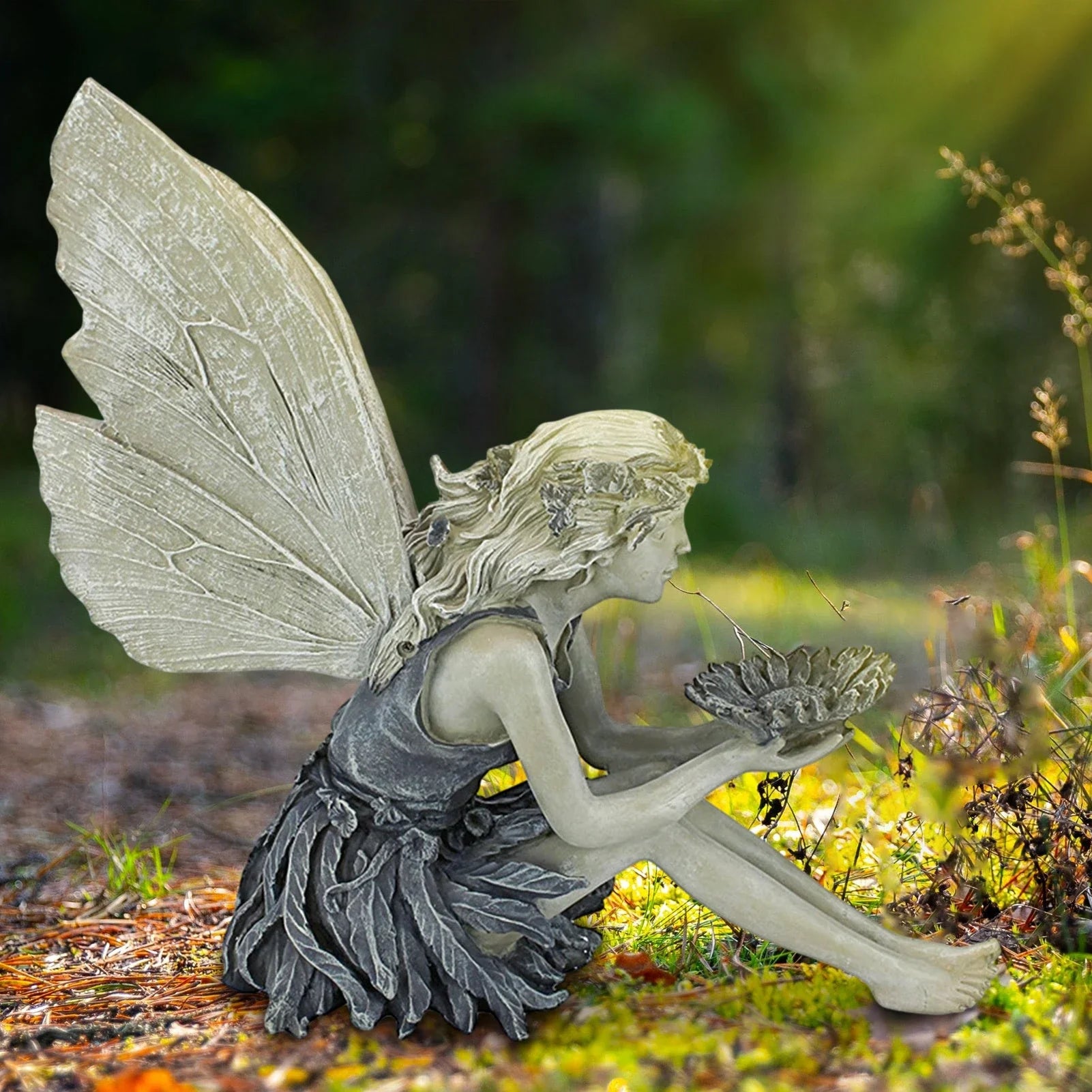 A charming resin fairy statue holding a sunflower bowl, with a flower crown and petal-inspired skirt, designed for outdoor garden decor