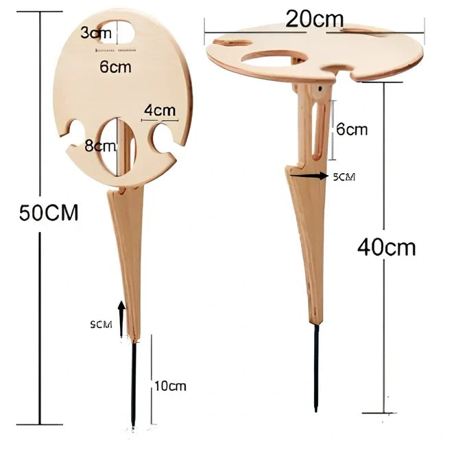 Wooden folding wine table with ground stakes holding wine bottle and glasses outdoors