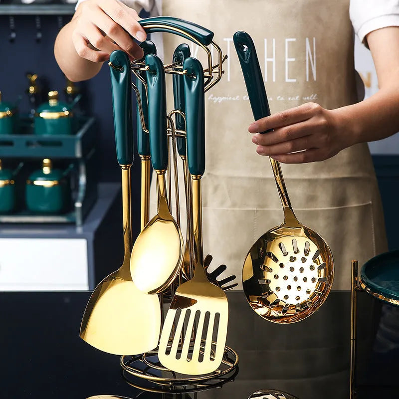 Seven-piece stainless steel kitchen utensil set with silicone handles including spatula, turner, ladle and serving spoon