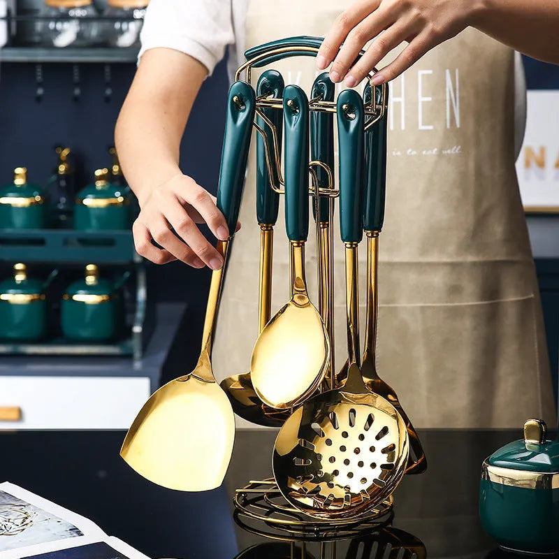 Seven-piece stainless steel kitchen utensil set with silicone handles including spatula, turner, ladle and serving spoon