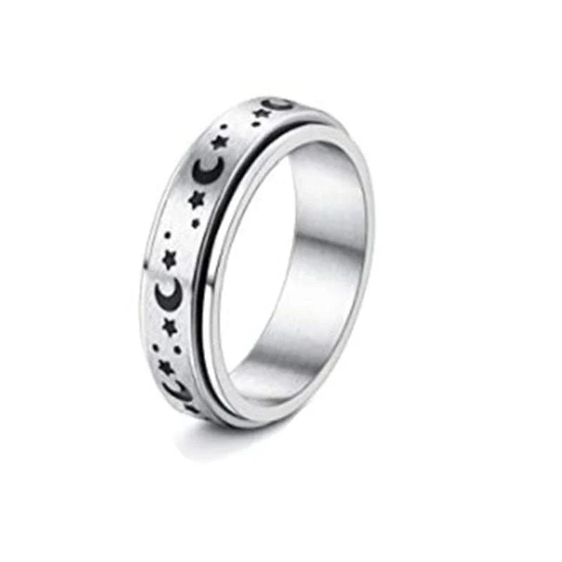 Stainless steel spinner ring with intricate moon and stars design