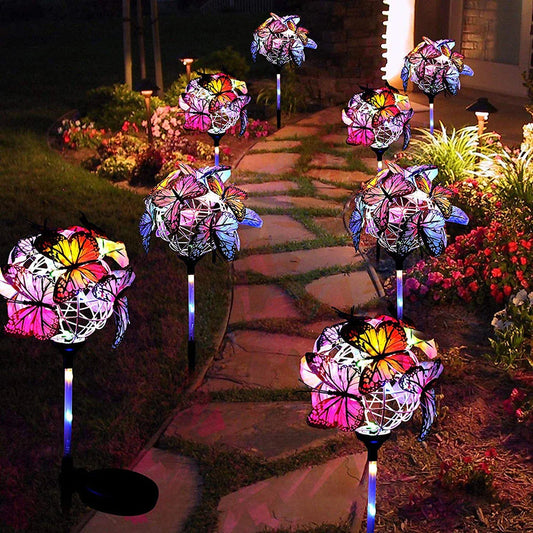 Solar-powered LED butterfly garden lights in black and transparent colors, creating a magical outdoor lighting display
