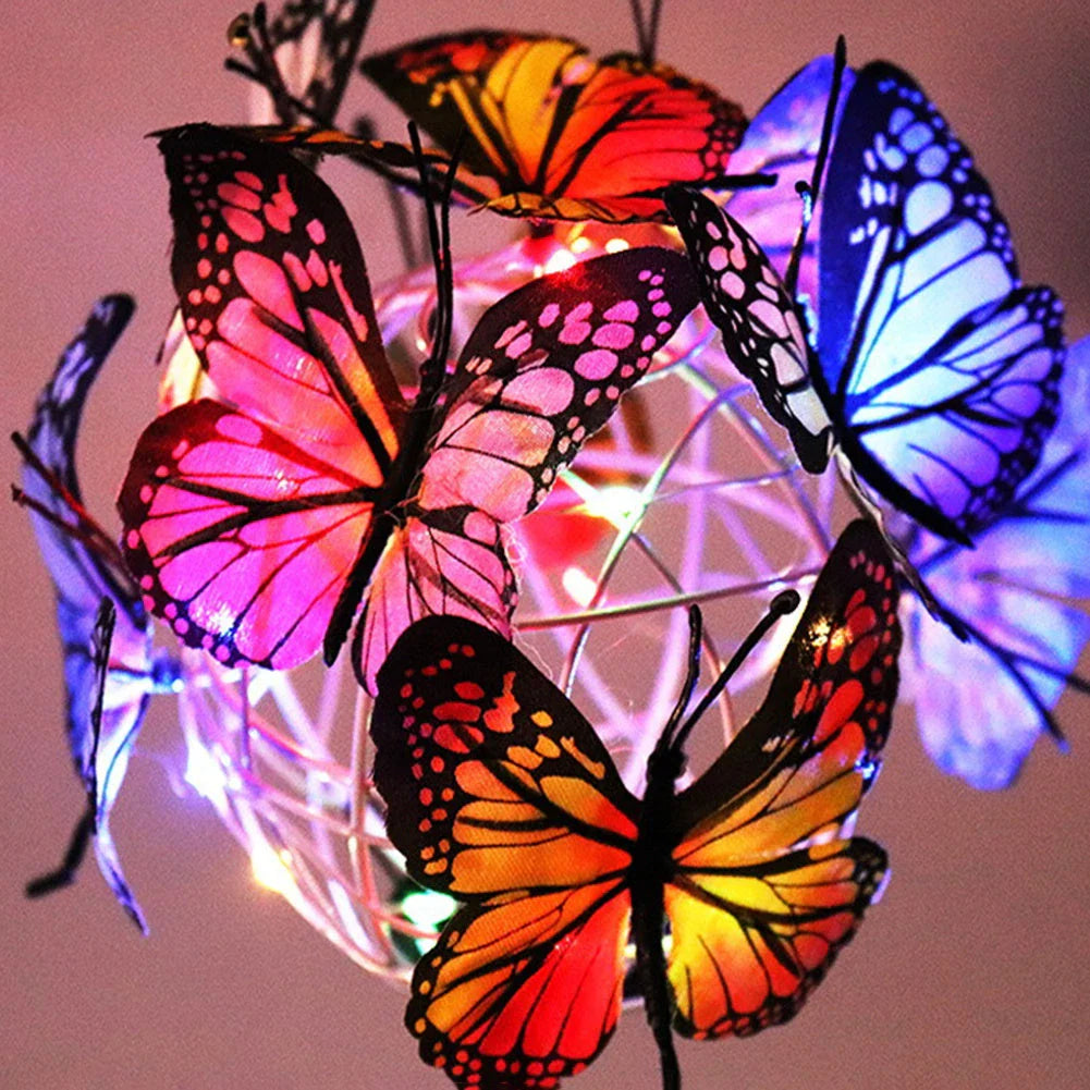 Solar-powered LED butterfly garden lights in black and transparent colors, creating a magical outdoor lighting display