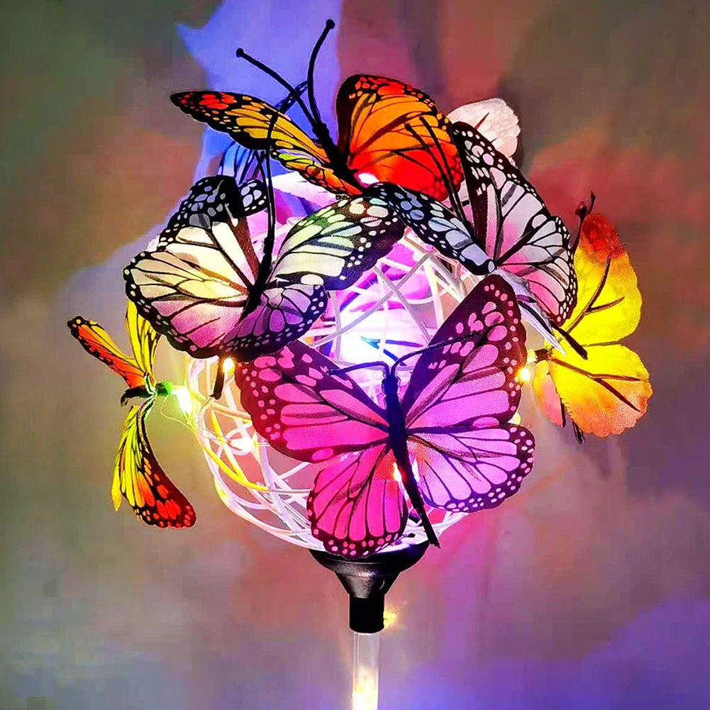 Solar-powered LED butterfly garden lights in black and transparent colors, creating a magical outdoor lighting display