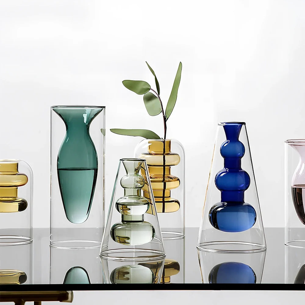 Transparent glass vase with colourful inner layer displaying dried flowers, 15cm tall on wooden table