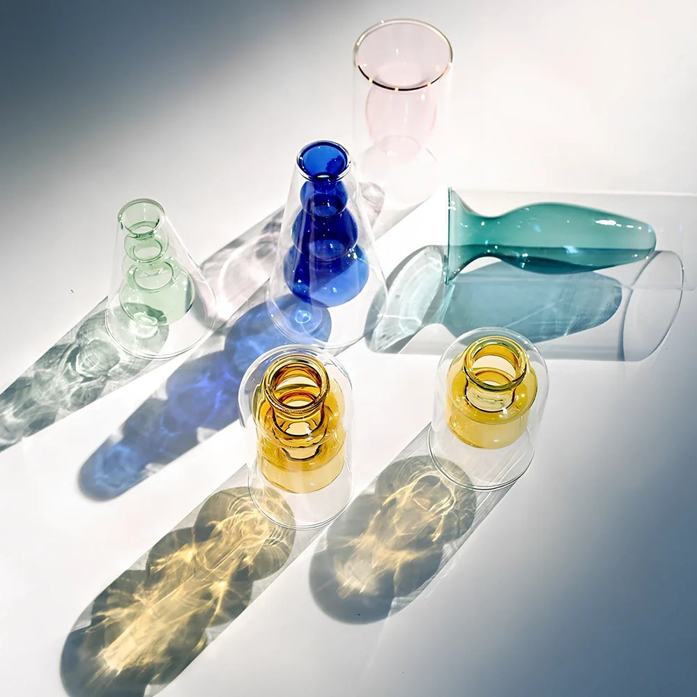 Transparent glass vase with colourful inner layer displaying dried flowers, 15cm tall on wooden table