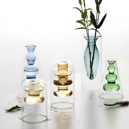 Transparent glass vase with colourful inner layer displaying dried flowers, 15cm tall on wooden table