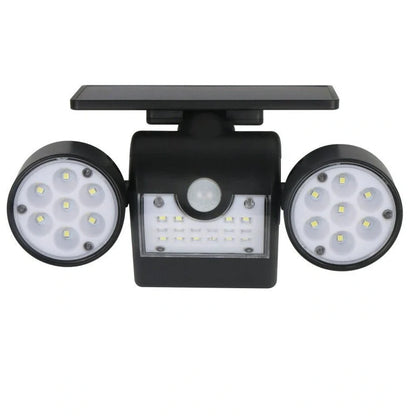 White solar garden light with two adjustable spotlight heads mounted on stake