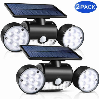 White solar garden light with two adjustable spotlight heads mounted on stake