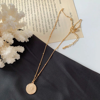 Gold alloy abstract face choker necklace with geometric pendant