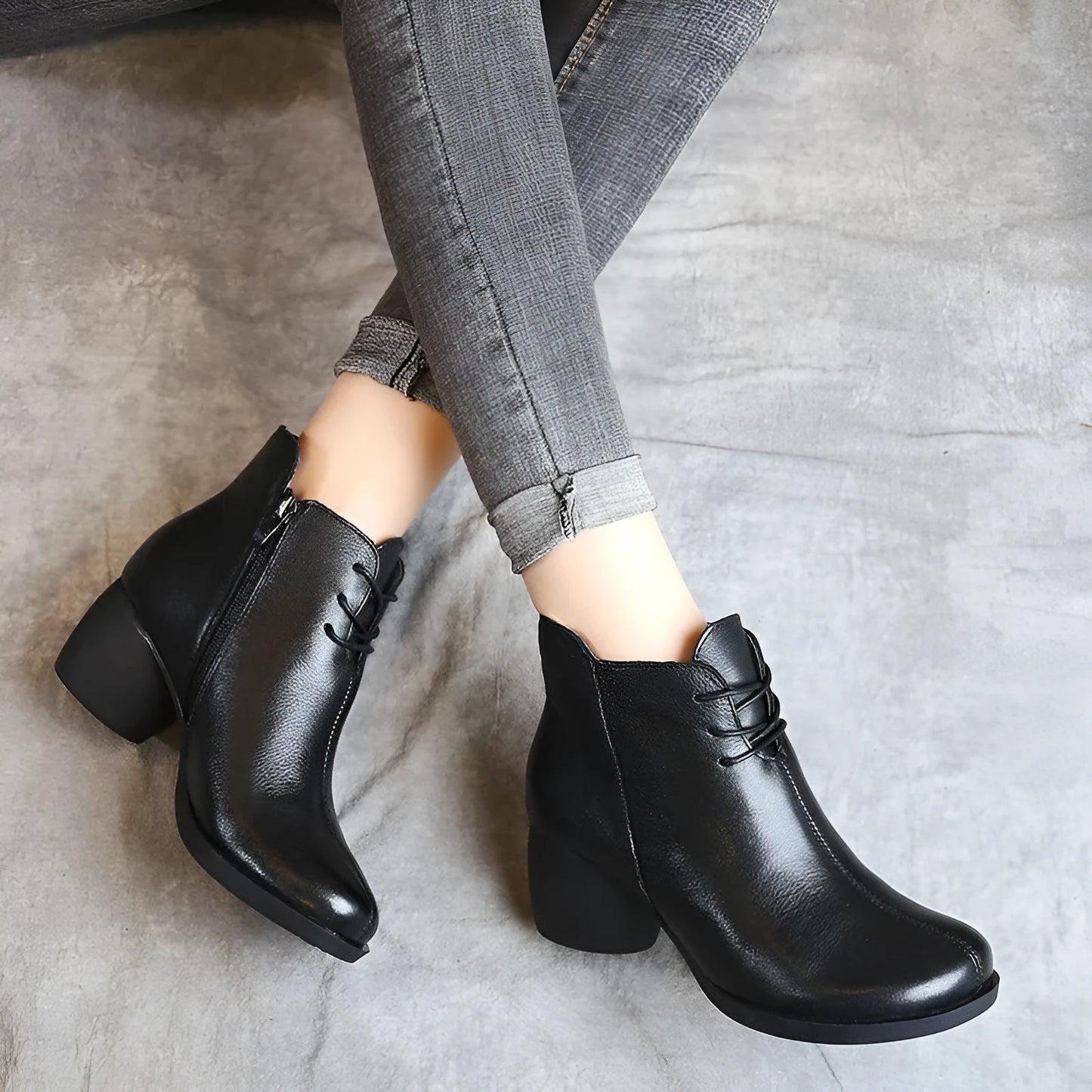 Women's brown leather retro Martin boots with a thick block heel and round toe on a wooden floor.