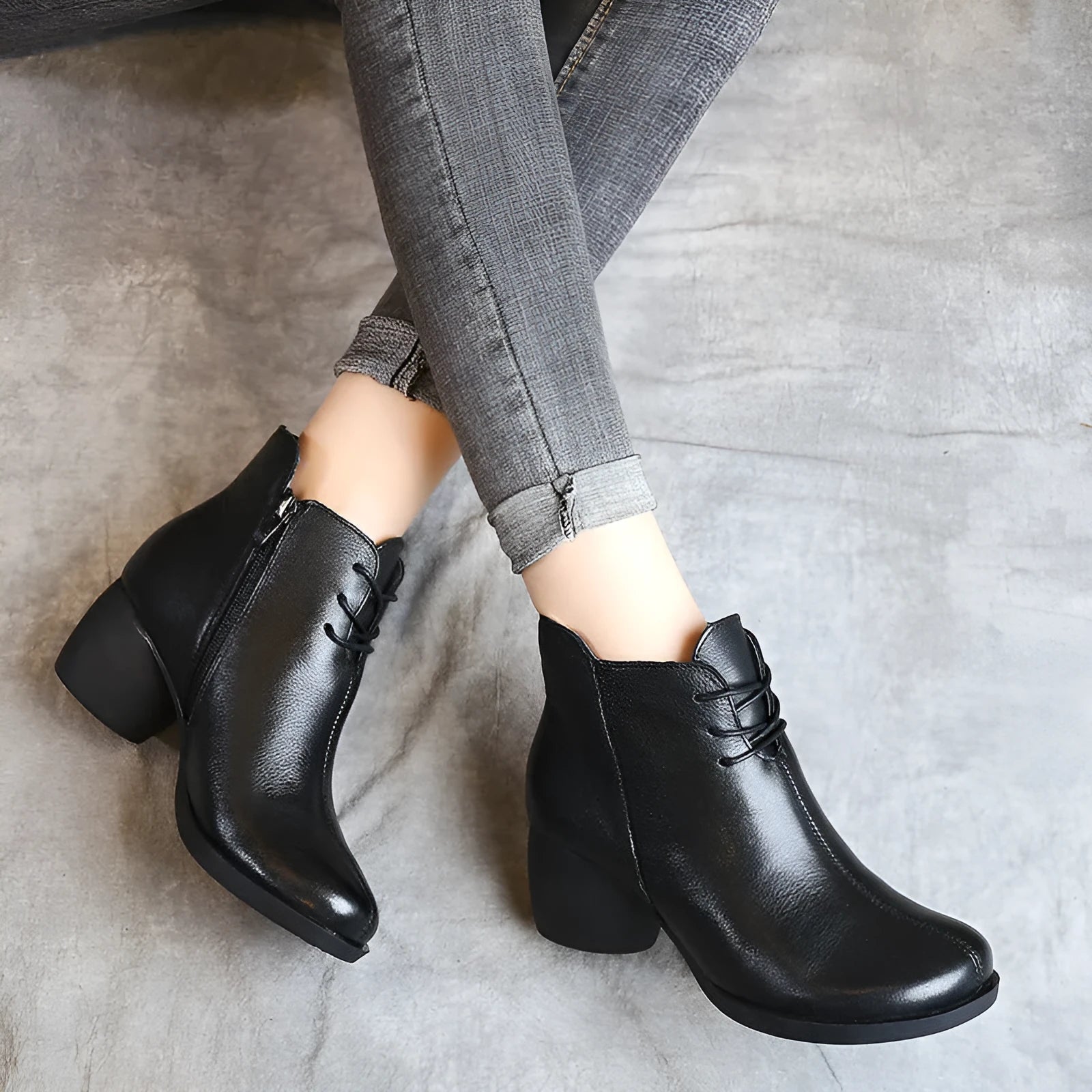 Women's brown leather retro Martin boots with a thick block heel and round toe on a wooden floor.