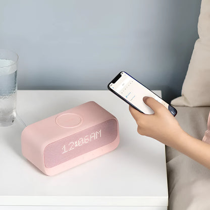 White Anker Soundcore all-in-one Bluetooth speaker with wireless charging pad and alarm clock display.