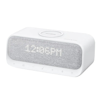 White Anker Soundcore all-in-one Bluetooth speaker with wireless charging pad and alarm clock display.