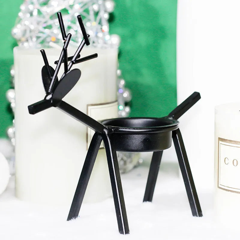 Black iron Christmas candlestick holder with elk bracket design and Santa Claus motifs