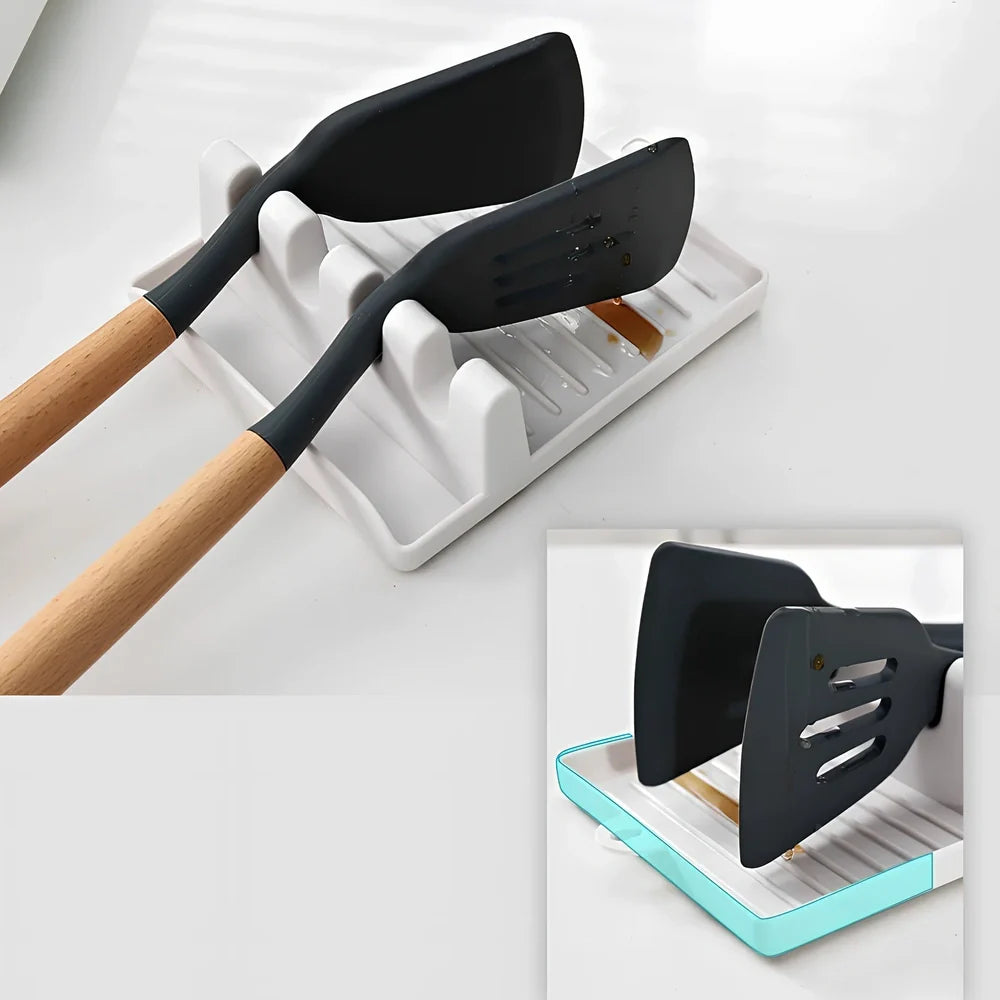 Green silicone spatula holder with four slots for kitchen utensils on countertop