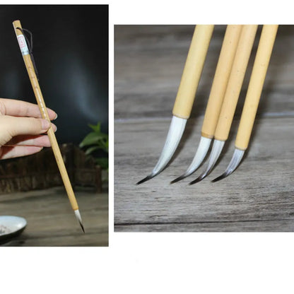 Four traditional Chinese calligraphy brushes with thin gold bodies and pine branch design