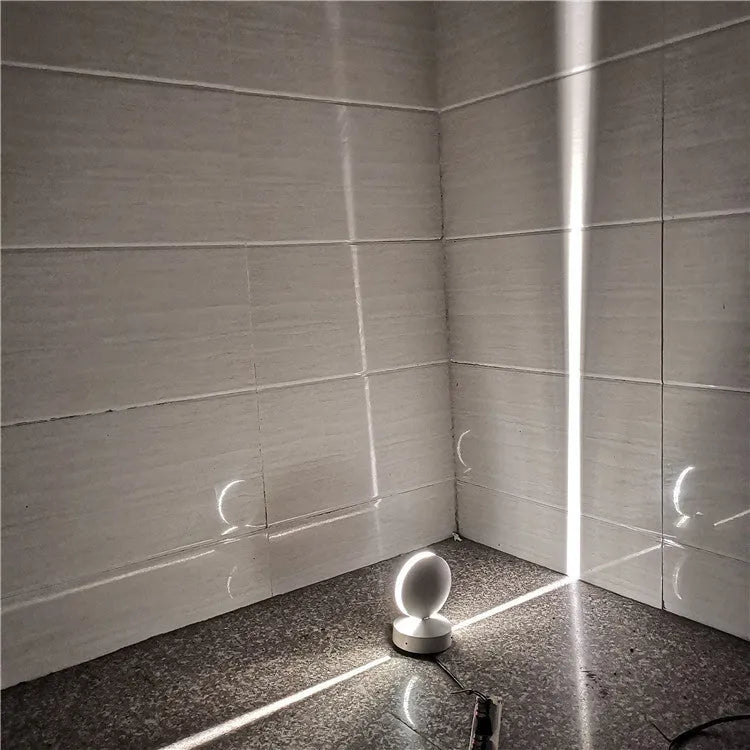 Aluminium and glass LED wall spotlight bar with colour change options, mounted on a corridor wall.