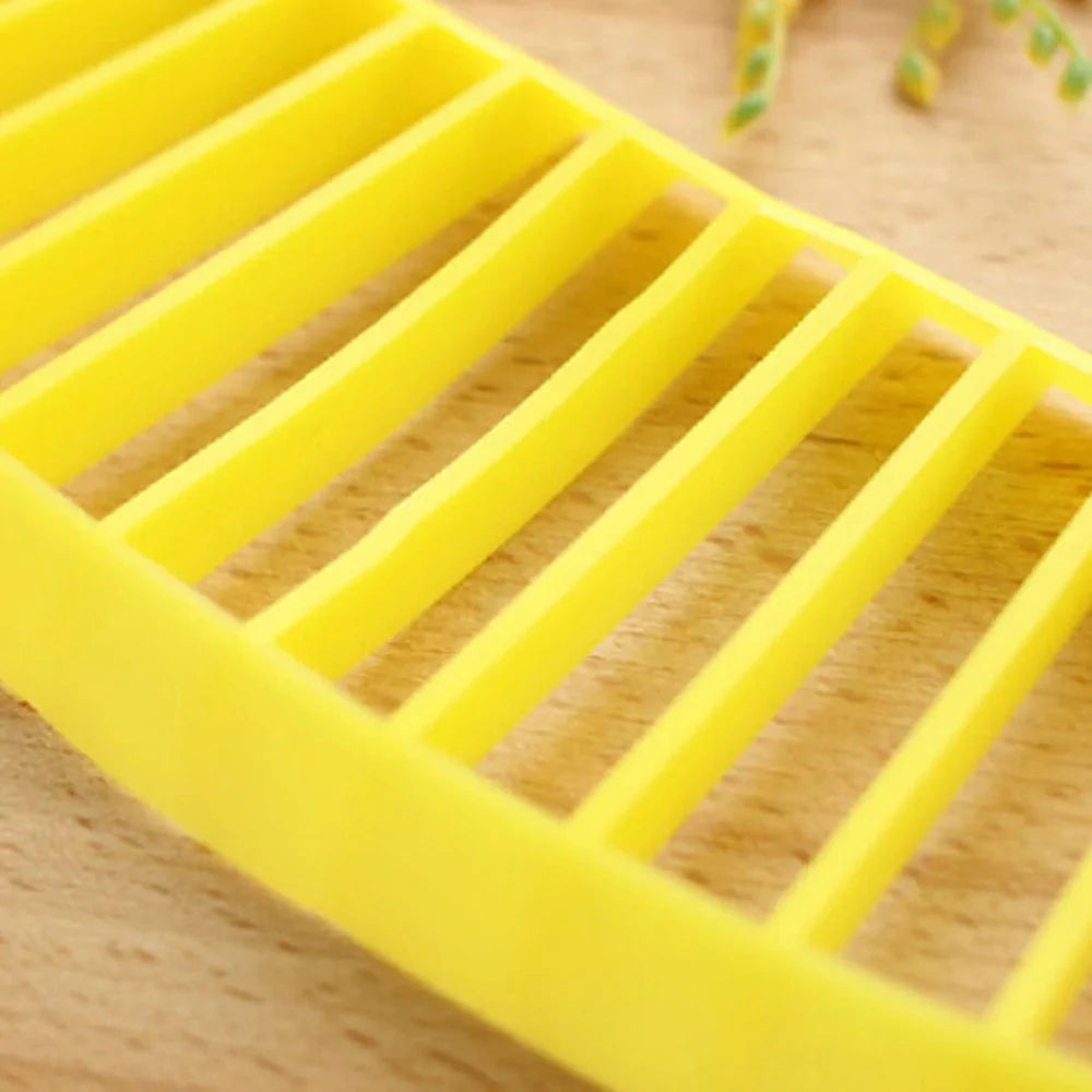 Yellow food grade PP banana cutter, 25 cm long, slices entire fruit in one quick motion for easy kitchen prep