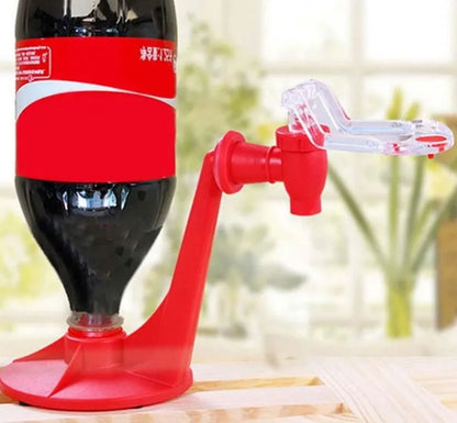 Red plastic soda dispenser attached to inverted 2-litre bottle with push-button mechanism
