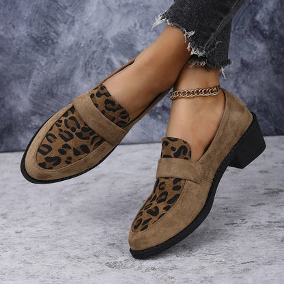 Leopard print slip-on suede pump shoe with chunky mid heel and pointed toe on a rubber sole.