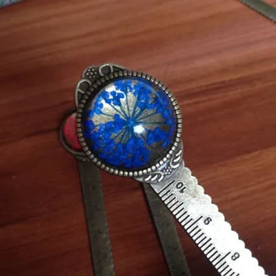 12cm handmade dried flower bookmark with gypsophila ruler featuring lace flowers, daffodils, and clover on blue background