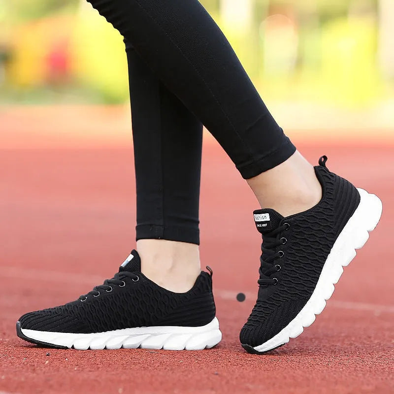 Women's running shoes with fly weaving upper material and wear-resistant outsole in black, pink, white colours