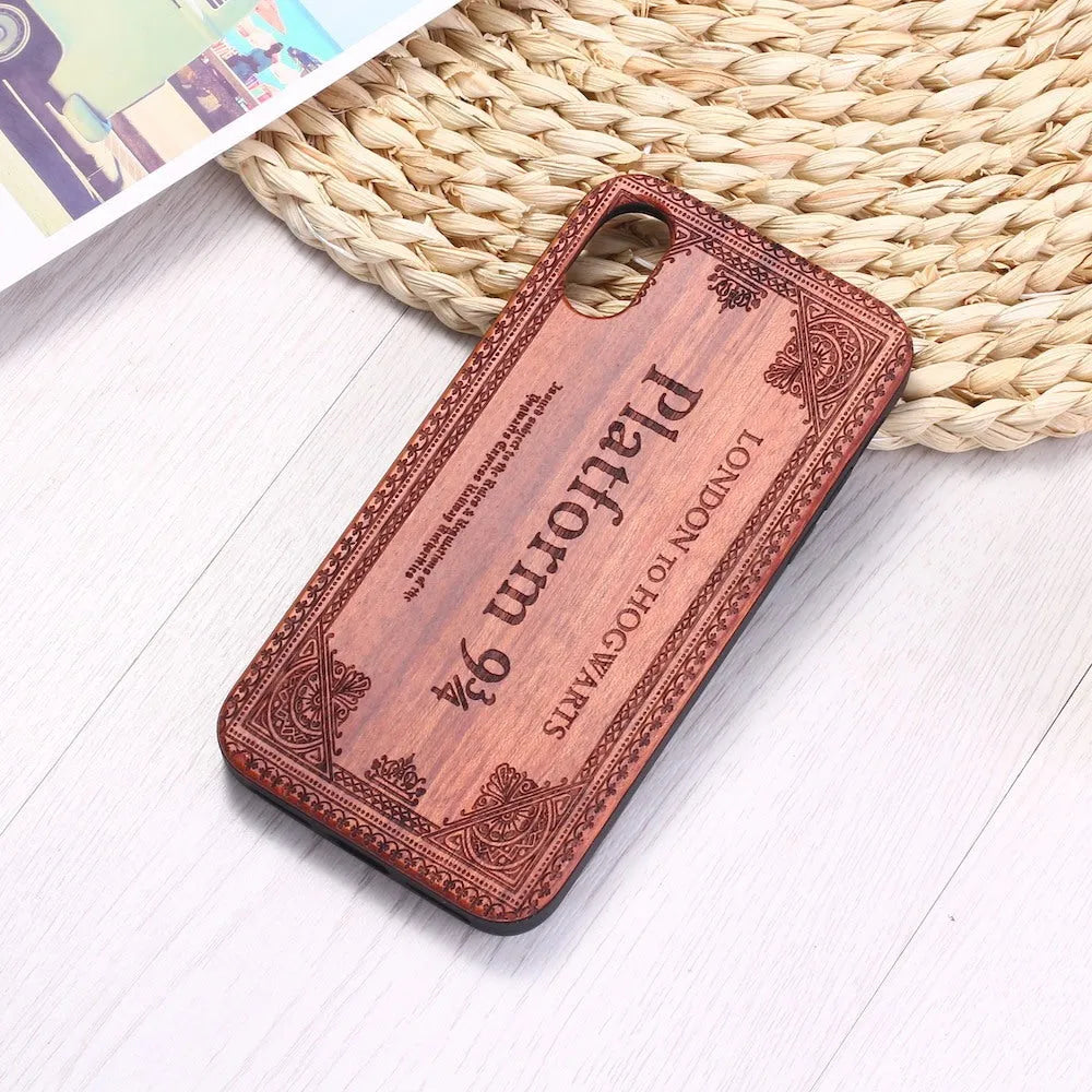 Wooden iPhone case with a laser-carved floral design and a black TPU bumper, shown fitted on an iPhone.