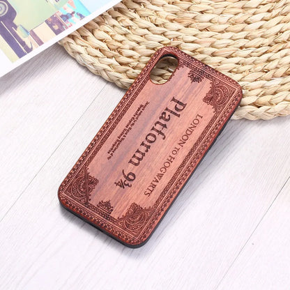 Wooden iPhone case with a laser-carved floral design and a black TPU bumper, shown fitted on an iPhone.