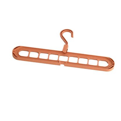 Green nine-hole folding hanger with trousers organised across nine hanging points, showing 45cm width