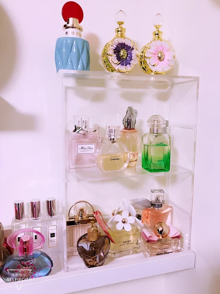 Clear acrylic cosmetic storage box measuring 24x10x34cm with transparent sides showing makeup organisation